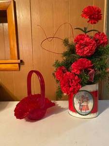 lot 103 image: Christmas FlowersTin and Red Basket