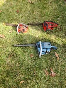 lot 13 image: lot of 3 home lite vintage chain saws. Blue one started with light spray of ether and gas. other 2 did not start with just gas