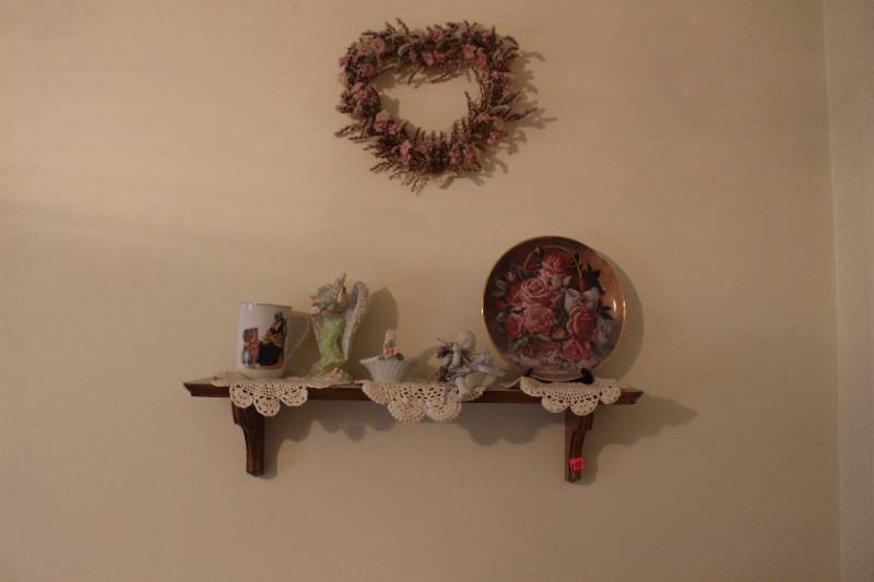 lot 173 image: Shelf with contents and heart on wall