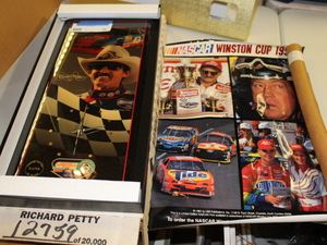 lot 44 image: Richard Petty Clock and NASCAR Poster Lot
